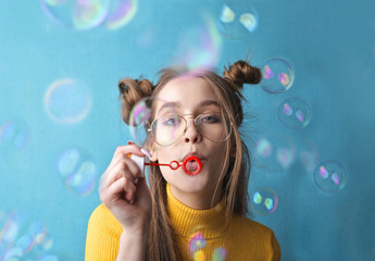 pretty young girl blowing bubbles.