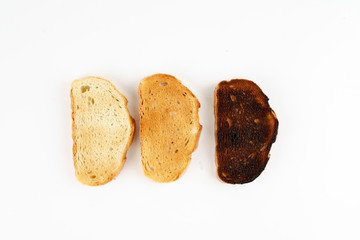 Three toasts in different stages of roasting, top view