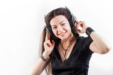 Young brunette woman in large headphones listening to music and having fun.
