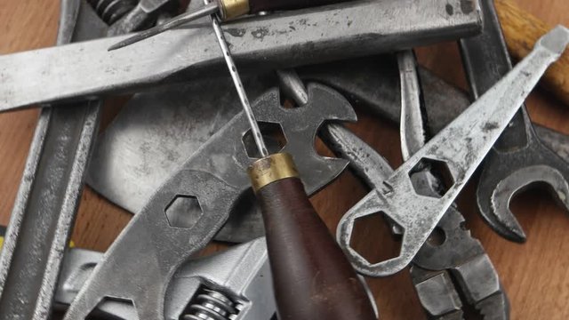 Old locksmith tools laid out on the wooden board, background