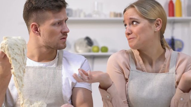 Young family couple failed trying to make dough, lack of cooking experience