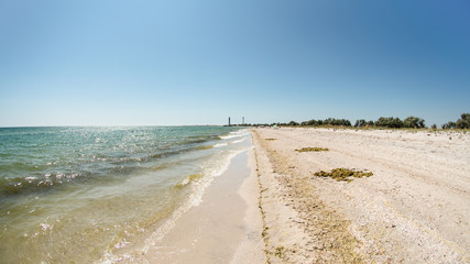 Coast of Dzharylhach island it the Black Sea, Ukraine. Two lighthouses far away in the background