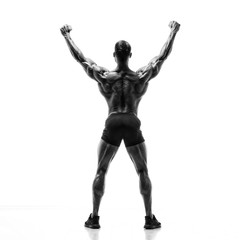 Black and White image of Strong Muscular Men Flexing Muscles from the Back. He is showing back muscles development