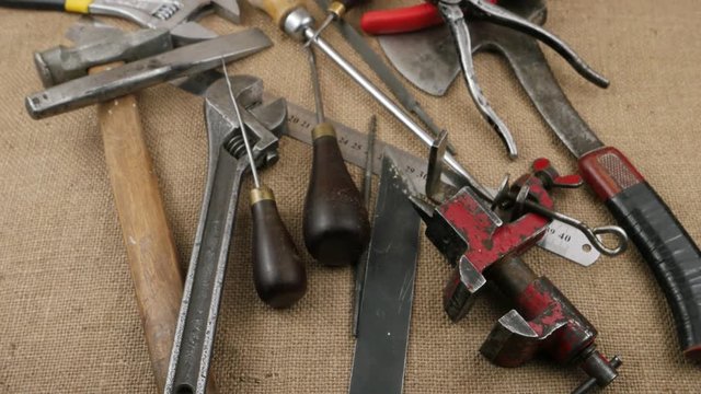 Old locksmith tools laid out on the burlap, background