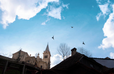 The Cathedral of St. Joseph in Sighisoara against a bright blue sky