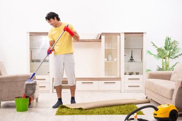 Young handsome man doing housework 