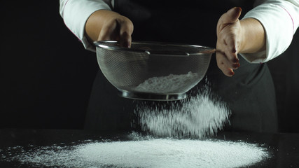 Sift the flour through a sieve for making bread or pancakes for breakfast.