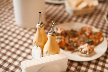 Close up view of table decoration in the Italian restaurant. Romantic evening atmosphere in europe. Tableware, food, flowers and wine glass.