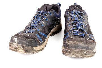 dirty used worn out black outdoor sneakers isolated on white