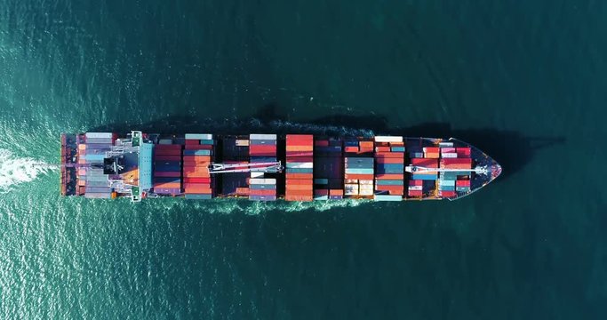 Aerial top view container ship running with wave in sea, thailand.