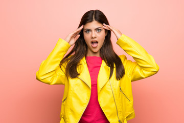 Teenager girl over pink wall with surprise expression