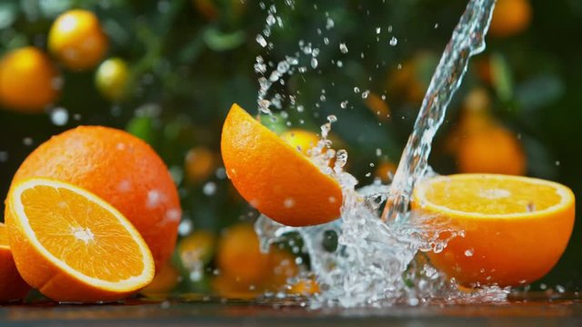 Super Slow Motion Shot of Falling Orange with Water Splash at 1000 fps.