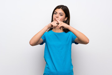 Teenager girl with blue shirt showing a sign of silence gesture