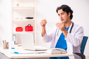 Young male doctor with goniometer 