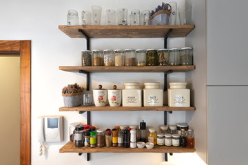 Kitchen shelves with various food ingredients and spices, Industrial kitchen shelves with food and spices 