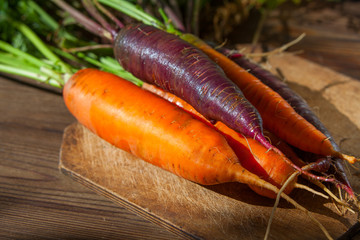 raw ripe carrots on  wooden table