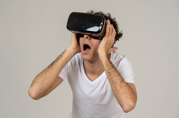 Young man having a scary experience with Virtual Reality goggles shouting in shock