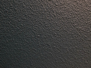Black plastered textured wall. Abstract background texture concept
