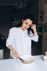 Tired mom cooks dinner in the kitchen