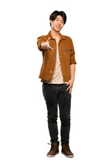 Fototapeta premium A full-length shot of a Asian man with brown jacket shaking hands for closing a good deal over isolated white background