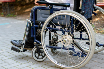 Fototapeta na wymiar disabled person in a wheelchair on the street a young guy in a wheelchair