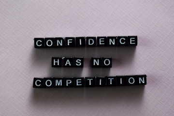 Confidence has no competition on wooden blocks. Motivation and inspiration concept