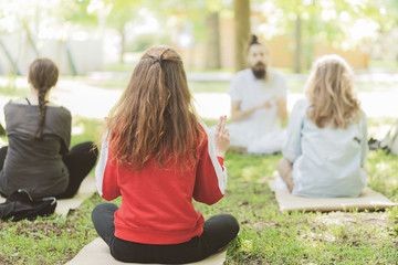 Woman doing yoga on the park - beautiful lights.relax in nature on the park .