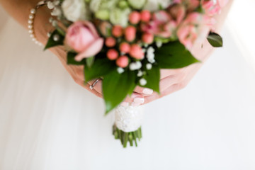 Wedding bouquet in the hands of the bride