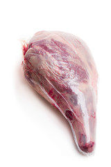 Vacuum pack of raw lamb leg isolated on white