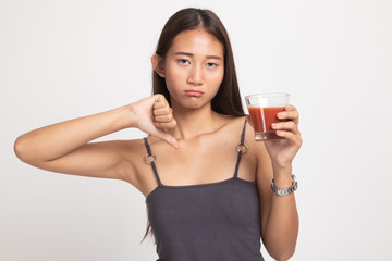 Asian woman thumbs down  hate tomato juice.