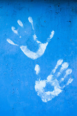 White hand print on blue background