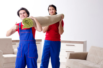 Two young contractor employees moving personal belongings 