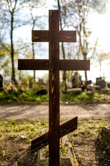 Grave cross on the Orthodox Christian cemetery at sunny day.