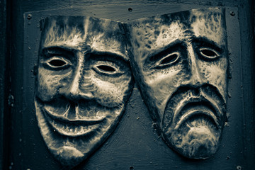comedy and tragedy steel masks painted in golden and dark blue colors