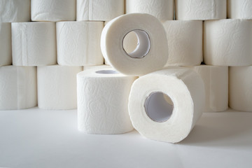 three rolls of toilet paper on toilet paper background