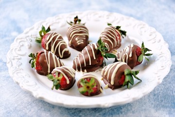 Delicious fresh strawberries in milk and white chocolate.