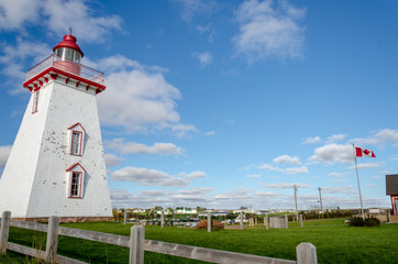 East Point Lighthouse PEI , with the Canadian flag far right of the light house