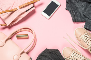 Woman fashion cloth and accessories on pink background.