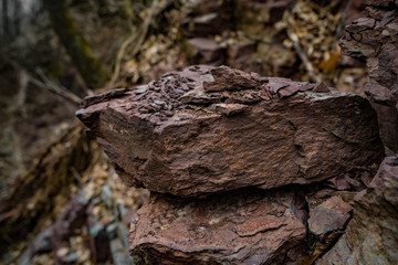 Red and blue cracked rock closeup , with blur background