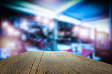 Table background of free space for your decoration and blurred bar. Night Club interior. 