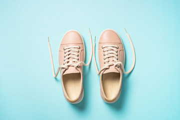 Woman fashion pink shoes on blue background.