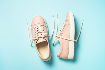 Woman fashion pink shoes on blue background.