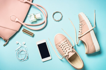 Woman accessories on blue background.