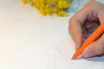 the girl is writing a letter on a piece of paper