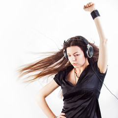 Young stylish woman in large headphones listening to music and having fun.