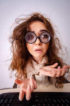 Funny nerd girl working on computer