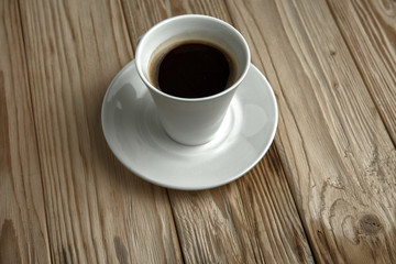 Hot coffee on a wooden stand, top view
