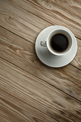 Hot coffee on a wooden stand, top view