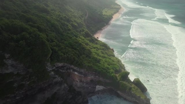 Aerial view of the cliff and rocky coast with surf the waves.