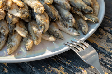 fried smelt on a plate. close up